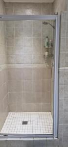 a shower with a glass door in a bathroom at The Barn Haven in Kyalami +11 photos