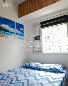 a bedroom with a bed and a window at MiCasa South Residences Cozy & Affordable Stay in Manila +18 photos