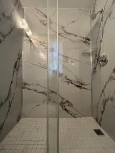 a shower with a glass door in a bathroom at Mountain View Motel in Barrys Bay +42 photos