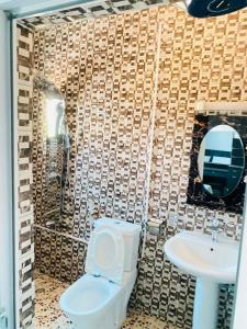 a bathroom with a toilet and a sink at Amie's Villa Apartment in Jarbang +32 photos