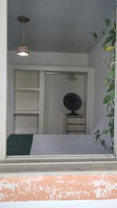a bedroom with a bed in a room with shelves at Quarto privativo em casa compartilhada in Aracaju +3 photos