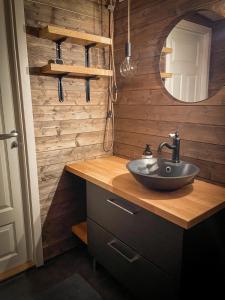 a bathroom with a sink and a mirror at Cabin Lyseren in Omberg +60 photos
