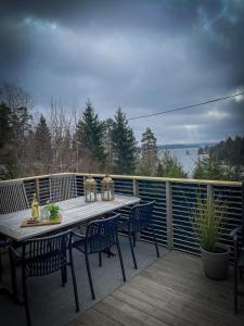 a wooden deck with a table and chairs on it at Cabin Lyseren in Omberg