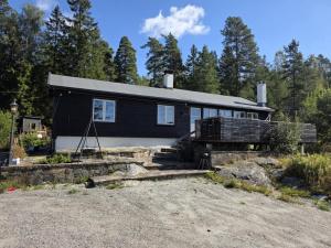 a black and white house in the woods at Cabin Lyseren in Omberg