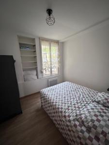 a bedroom with a bed and a window at Villa Juliette in Le Tréport