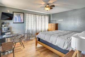 a bedroom with a bed and a table and a kitchen at Lake Ozark Stay for Shootout Weekend in Lake Ozark +20 photos