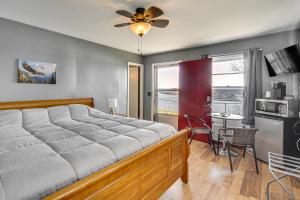 a bedroom with a large bed and a table and chairs at Lake Ozark Stay for Shootout Weekend in Lake Ozark