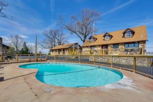 a house with a pool in front of a fence at Lake Ozark Stay for Shootout Weekend in Lake Ozark