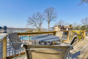 a patio with a table and chairs on a deck at Lake Ozark Stay for Shootout Weekend in Lake Ozark