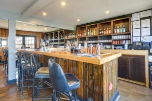 a bar in a restaurant with chairs around it at Lake Ozark Stay for Shootout Weekend in Lake Ozark