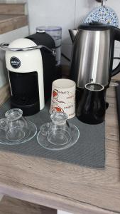 a counter with two glass plates and a coffee maker at "Da Zia House Comfort e Relax vicino a Torino" in Brandizzo