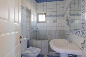 a bathroom with a toilet and a sink and a tub at Methoni Beach Hotel in Methoni +22 photos