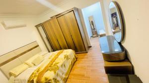 a bedroom with a bed and a wooden door at فيلا الكينج مريوط in King Mariout +30 photos