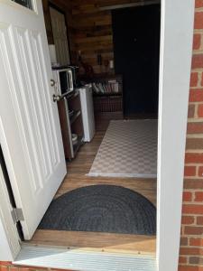 an open door to a room with a rug at Flower Avenue Hosting - Private Suite with De Luxe King Size Bed - 77 per Night 1st guest - 59 2nd guest - 52 each third & 4th guests in Silver Spring +26 photos