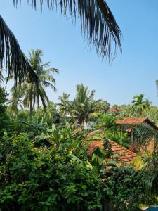 a view of a resort with palm trees and a building at Wings Hotel & Hostel in Trincomalee