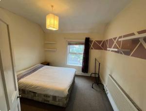 a small bedroom with a bed and a window at Bayview in Ballysadare