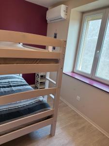 a room with a bunk bed and a window at Petite Chambre lit Superposée in Toul