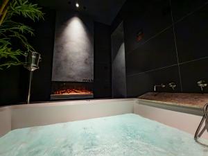 a bath tub with a fireplace in a room at B Suite Spa in Palermo