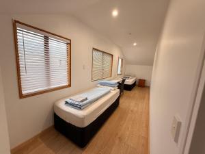 two twin beds in a room with a window at Qt inntouch in Queenstown +41 photos