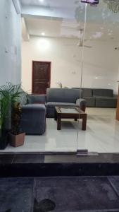 a living room with a couch and a coffee table at Wings Hotel & Hostel in Trincomalee