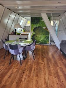 a kitchen and dining room with a table and chairs at Nurdachhaus Ferienpark Schellbronn in Schellbronn