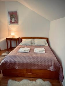 a bedroom with a bed with two towels on it at Jarmočná Apartmán in Stará Ľubovňa