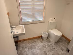a bathroom with a toilet and a sink at Qt inntouch in Queenstown