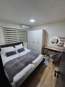 a bedroom with a large bed and a desk at Royal in Sarajevo