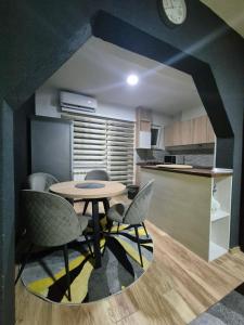 a kitchen with a table and chairs in a room at Royal in Sarajevo