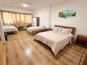 a bedroom with two beds and a table in it at ROOM AYAMPE - La Casa de Eros in Ayampe +37 photos