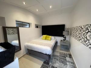 a small bedroom with a bed and a mirror at Home Mark Casa Boutique in Paipa +20 photos