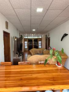 a living room with a table and a couch at ROOM COLIBRÍ - La Casa de Eros in Ayampe
