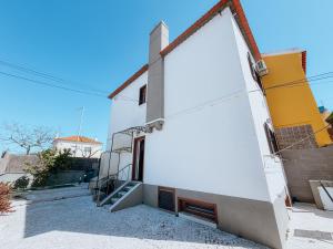 a white building with a staircase on the side of it at Villa Frescura do Mar by Casas de Setúbal in Setúbal