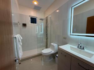 a bathroom with a toilet and a shower and a sink at MayaVilla in Long Swamp