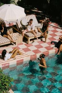 a group of people sitting in a swimming pool at Hotel Panamera in Tulum