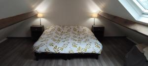 a bedroom with a bed and two lamps on the stairs at Studio Paisible in Nouzilly