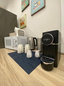 a kitchen with a coffee maker and a microwave at Halisa Casa Vacanze in Palermo