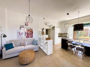 a living room with a couch and a table at Casa Melina - Pesaro Mare in Pesaro
