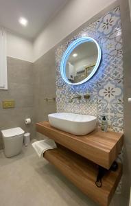 a bathroom with a sink and a mirror at Halisa Casa Vacanze in Palermo +17 photos