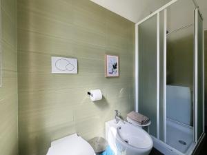 a bathroom with a sink and a toilet and a shower at Casa Melina - Pesaro Mare in Pesaro +5 photos