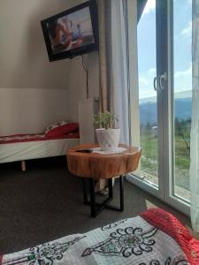 a room with a table in front of a window at Gorczańska EKO-SFERA in Wola Piskulina