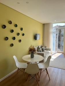 a living room with a table and a couch at Primeiro Quartel Apartments - 2 in Peso da Régua