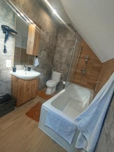 a bathroom with a tub and a sink and a toilet at Gorczańska EKO-SFERA in Wola Piskulina +71 photos