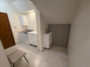 a small kitchen with a sink and a chair at MayaVilla in Long Swamp +15 photos