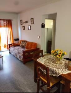 a living room with a table and a couch at La perla depto in Mar del Plata