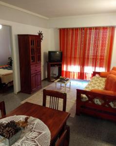 a living room with a couch and a table at La perla depto in Mar del Plata