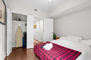 a bedroom with a red and white checkered blanket on a bed at Entire DC House 2BR 2BA Fire Pit Free Parking Near Capitol Hill in Washington, D.C.
