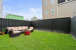 a backyard with two couches and a fence at Entire DC House 2BR 2BA Fire Pit Free Parking Near Capitol Hill in Washington, D.C.