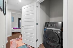 a white closet with a washing machine in a room at Entire DC House 2BR 2BA Fire Pit Free Parking Near Capitol Hill in Washington, D.C.
