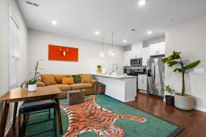 a living room with a couch and a table at Entire DC House 2BR 2BA Fire Pit Free Parking Near Capitol Hill in Washington, D.C.